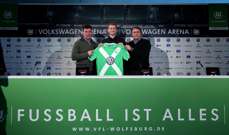 Andre Schuerrle (Mitte) beri der Vorstellung des VfL Wolfsburg, mit Klaus Allofs (R) und Wolfsburg's Trainer Dieter Hecking (L) AFP PHOTO / RONNY HARTMANN