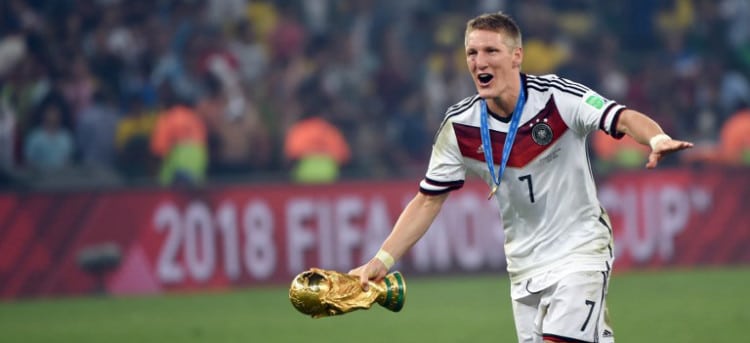 Germany's midfielder Bastian Schweinsteiger runs with the World Cup trophy as he celebrates with teammates after winning the 2014 FIFA World Cup final football match between Germany and Argentina 1-0 following extra-time at the Maracana Stadium in Rio de Janeiro, Brazil, on July 13, 2014. AFP PHOTO / PATRIK STOLLARZ