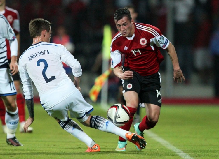 Albania's Taulant Xhaka (R) vies for the ball with Denmark's Peter Ankersen (L) during the Euro 2016 qualifying round football match between Albania and Denmark at the Elbasan Arena Stadium, on October 11, 2014 in Elbasan. AFP PHOTO / GENT SHKULLAKU