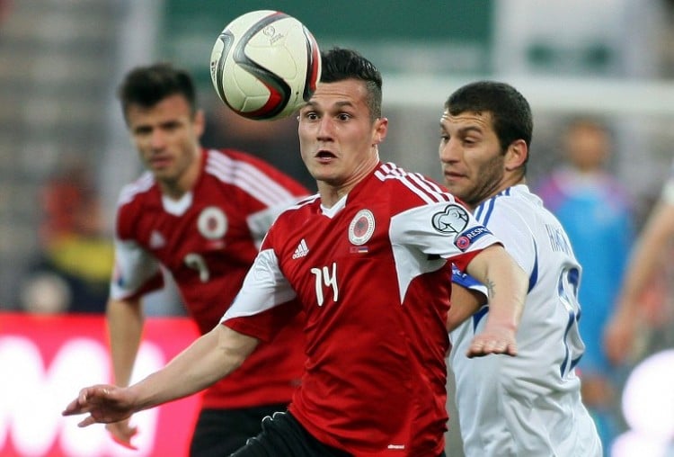 Albania's Taulant Xhaka (L) challenges Armenia's Hovhannes Hambardzumyan during the Euro 2016 group I qualifying football match between Albania and Armenia at Elbasan Arena in Elbasan on March 29, 2015. AFP PHOTO / GENT SHKULLAKU