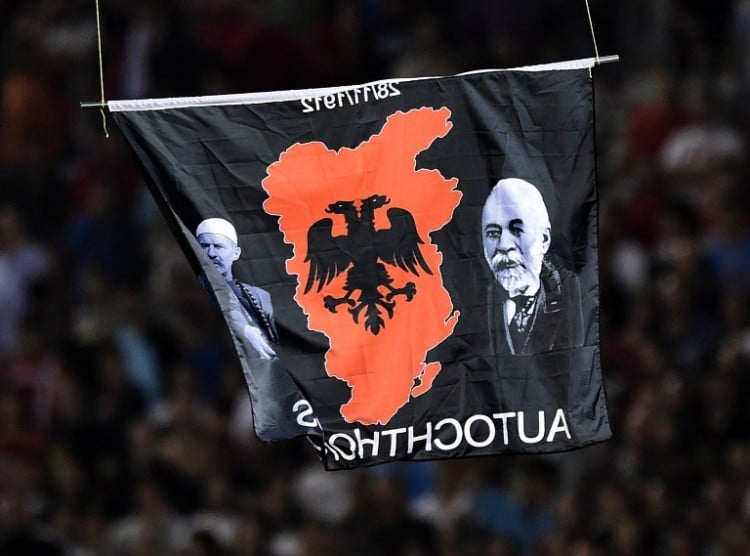 A flag with Albanian national symbols attached to a remotely operated drone flies in the stadium during the EURO 2016 group I football match between Serbia and Albania in Belgrade on October 14, 2014. AFP PHOTO / ANDREJ ISAKOVIC