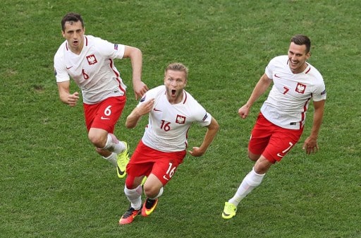 Poland's midfielder Jakub Blaszczykowski (C) celebrates after scoring during the Euro 2016 group C football match between Ukraine and Poland at the Velodrome stadium in Marseille on June 21, 2016. / AFP PHOTO / Valery HACHE