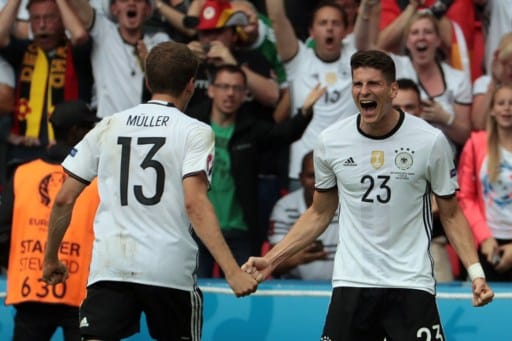 Germany's forward Mario Gomez (R) celebrates scoring the opening goal with Germany's midfielder Thomas Mueller during the Euro 2016 group C football match between Northern Ireland and Germany at the Parc des Princes stadium in Paris on June 21, 2016. / AFP PHOTO / KENZO TRIBOUILLARD