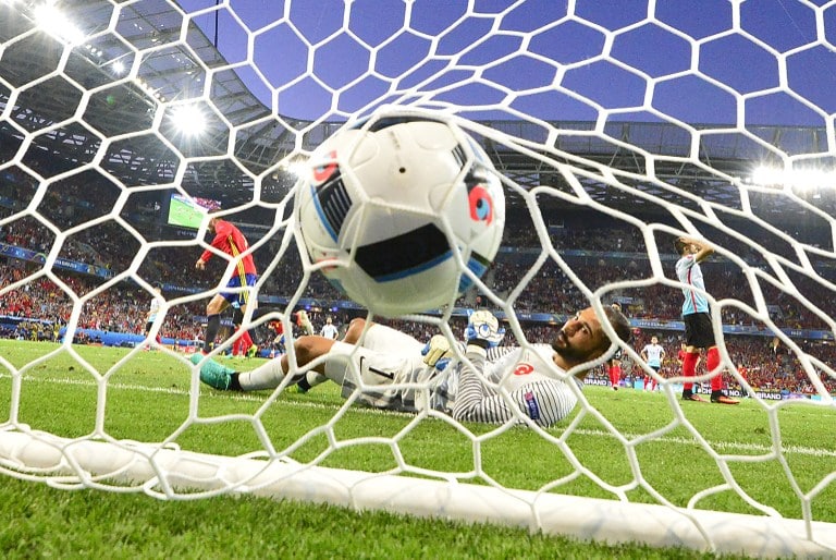 Turkey's goalkeeper Volkan Babacan lays in his goal as Spain scores the 1-0 during the Euro 2016 group D football match between Spain and Turkey at the Allianz Riviera stadium in Nice on June 17, 2016. / AFP PHOTO / BULENT KILIC