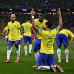 Der brasilianische Mittelfeldspieler Lucas Paqueta (Nr. 07) jubelt mit seinen Mannschaftskameraden nach dem vierten Tor seiner Mannschaft während des Achtelfinales der Fußballweltmeisterschaft Katar 2022 zwischen Brasilien und Südkorea im Stadion 974 in Doha am 5. Dezember 2022. (Foto von Pablo PORCIUNCULA / AFP)