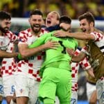 Der kroatische Torhüter Dominik Livakovic (Nr. 01) und seine Mannschaftskameraden feiern nach dem Sieg im Elfmeterschießen des Viertelfinales der Fußballweltmeisterschaft Katar 2022 zwischen Kroatien und Brasilien im Education City Stadium in Al-Rayyan, westlich von Doha, am 9. Dezember 2022, den Einzug in die nächste Runde. (Foto: GABRIEL BOUYS / AFP)