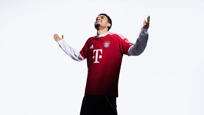 Diaz vom FC Bayern München reißt die Arme jubilierend in die Höhe – das offizielle Adidas Fotoshooting zum neuen roten Heimtrikot der Saison 2026/27. (Copyright Adidas)