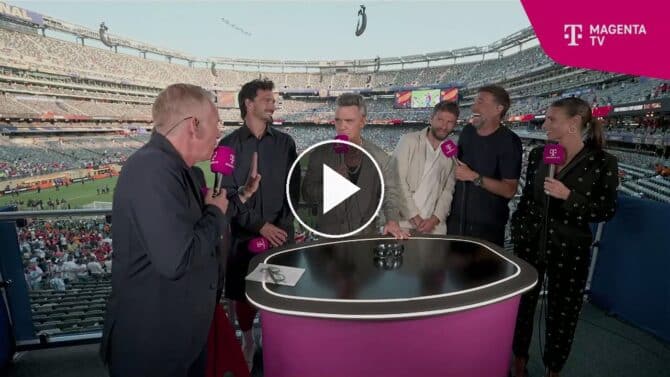 Robbie Williams steht nach dem WM-Finale 2026 im MagentaTV-Studio zwischen Jürgen Klopp, Thomas Müller und Mats Hummels